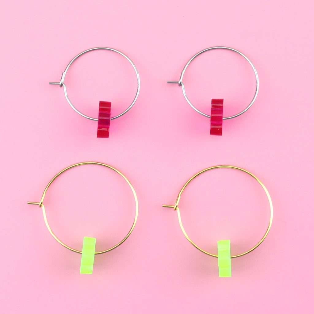 Green flower charms on gold hoops and pink flower charms on silver hoops