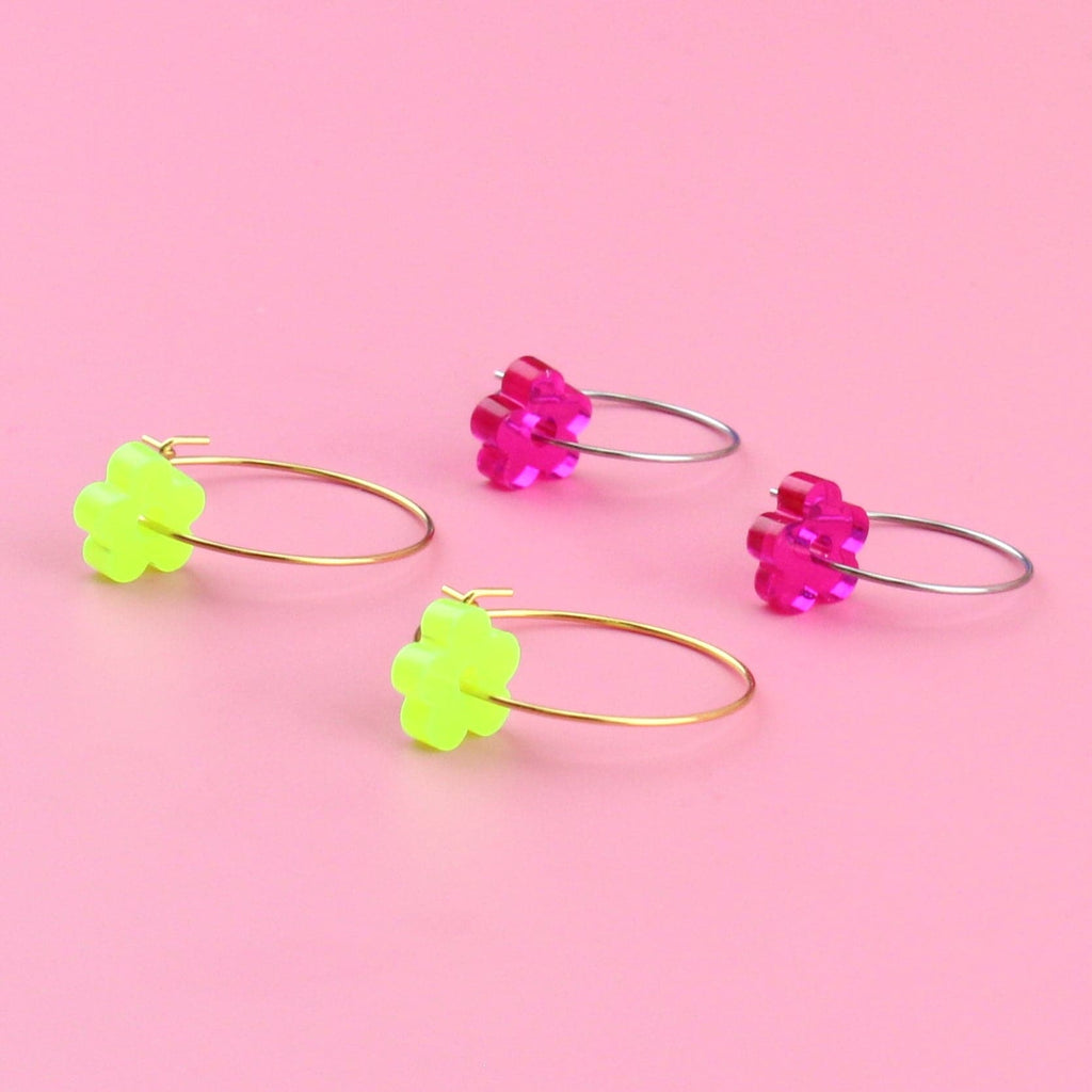 Green flower charms on gold hoops and pink flower charms on silver hoops