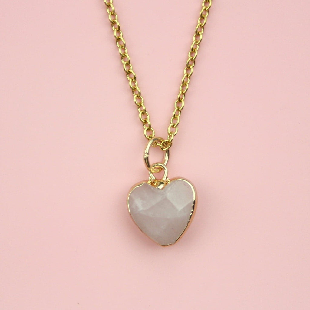 Rose quartz heart pendant with a gold outline on a gold plated stainless steel chain