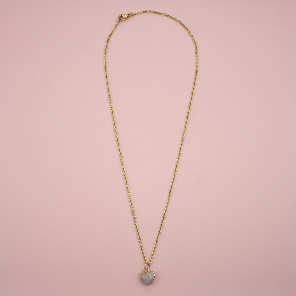 Rose quartz heart pendant with a gold outline on a gold plated stainless steel chain
