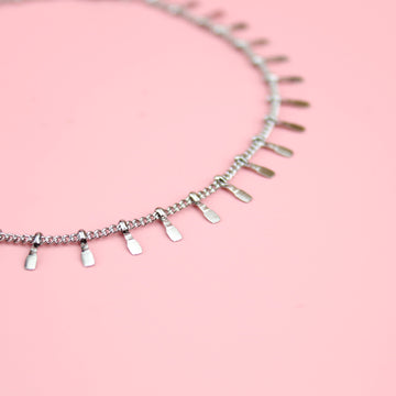 Stainless Steel Anklet featuring individual tassle hammered teeth charms