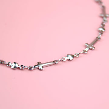Anklet made up of charms with the cross symbol on them