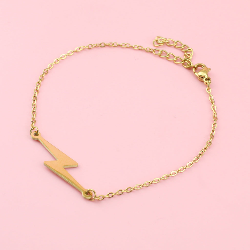 Gold plated stainless steel bracelet featuring a lightning bolt charm