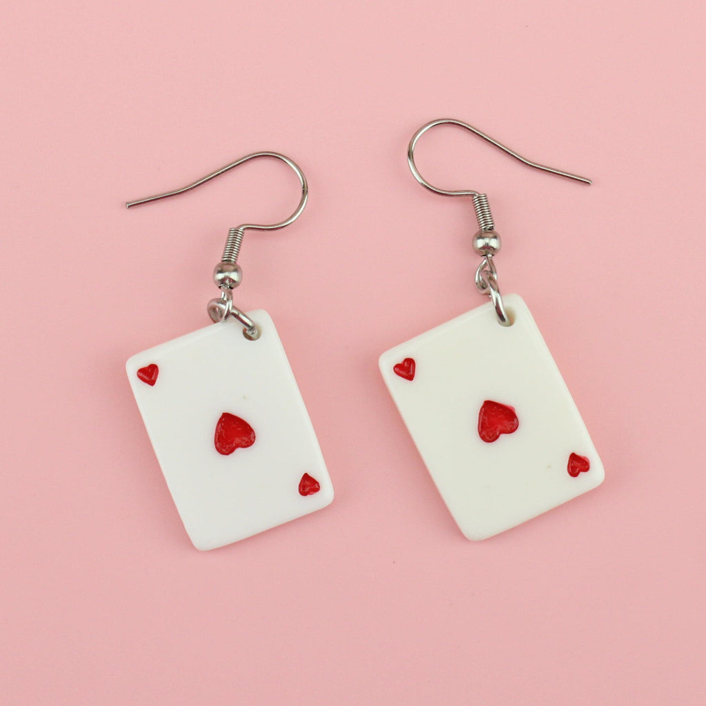 Earrings feature the ace of hearts playing card on stainless steel ear wires
