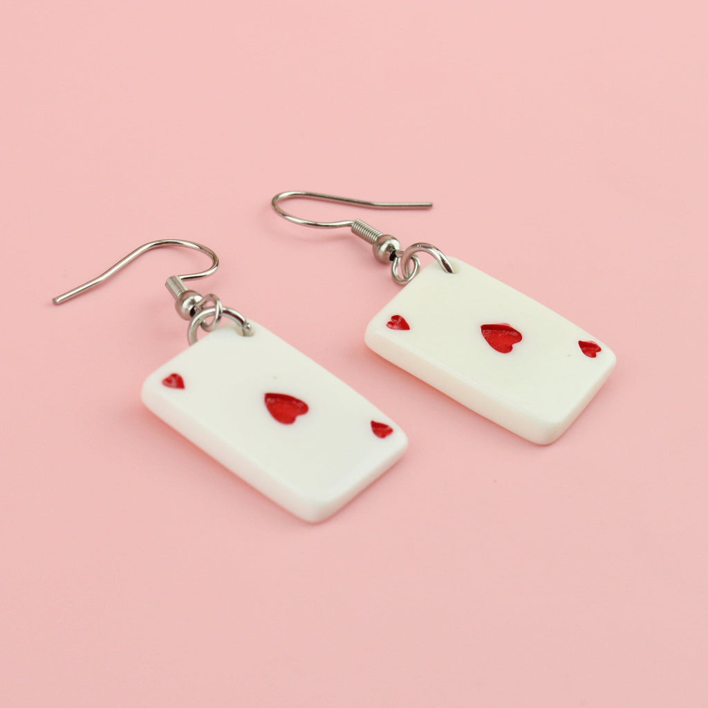 Earrings feature the ace of hearts playing card on stainless steel ear wires