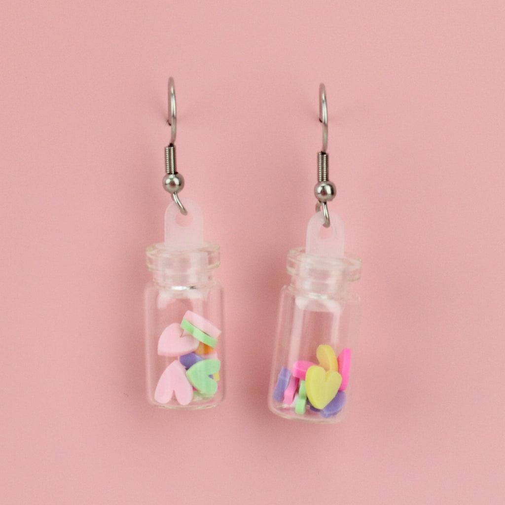 Bright, multi-coloured mini clay hearts in each glass bottle on stainless steel ear wires