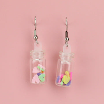Bright, multi-coloured mini clay hearts in each glass bottle on stainless steel ear wires