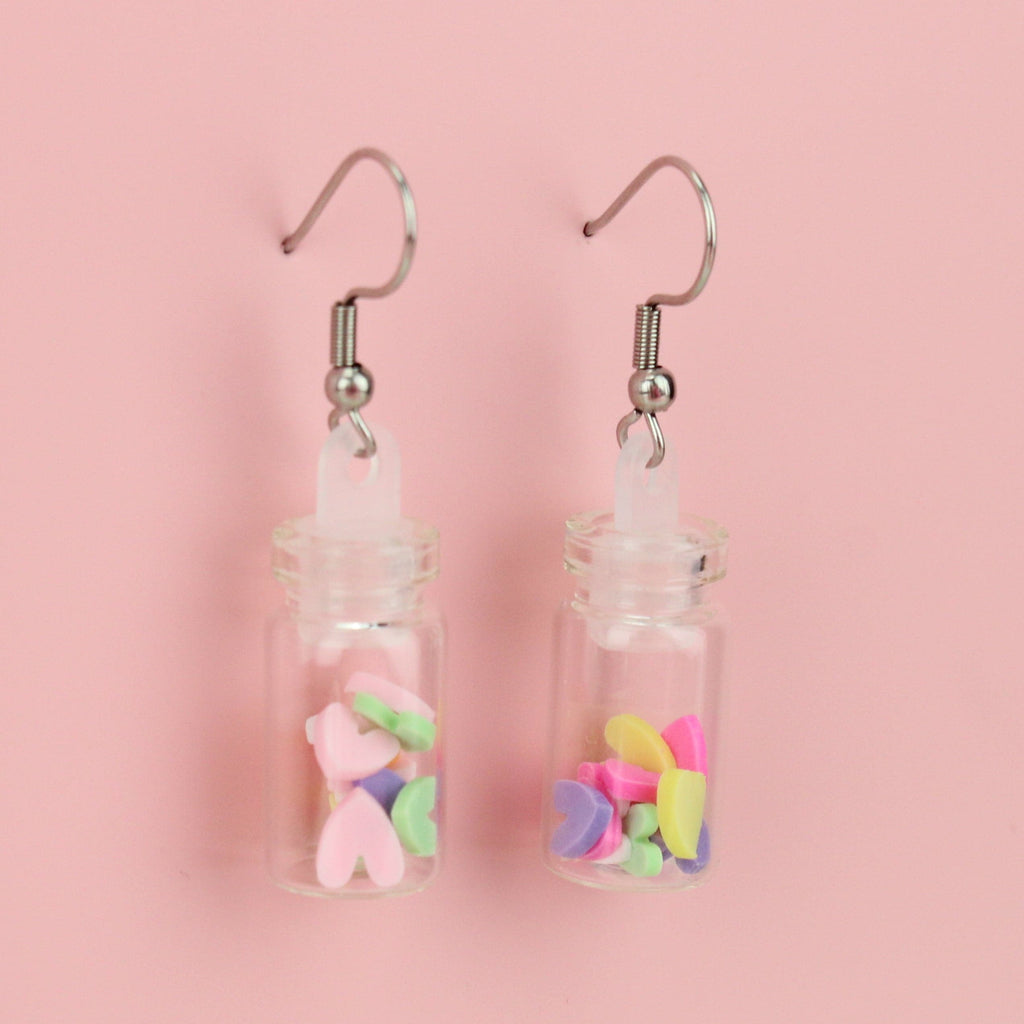 Bright, multi-coloured mini clay hearts in each glass bottle on stainless steel ear wires