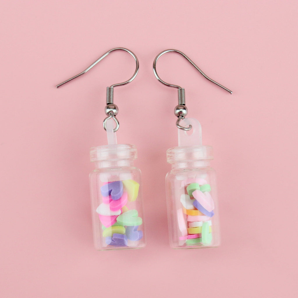 Bright, multi-coloured mini clay hearts in each glass bottle on stainless steel ear wires