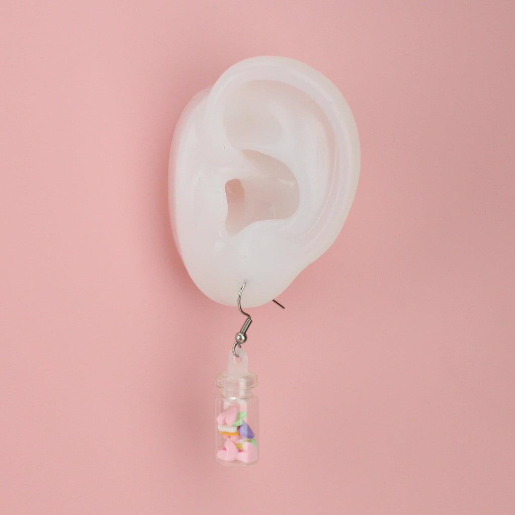 Ear showing Message In A Bottle Earrings