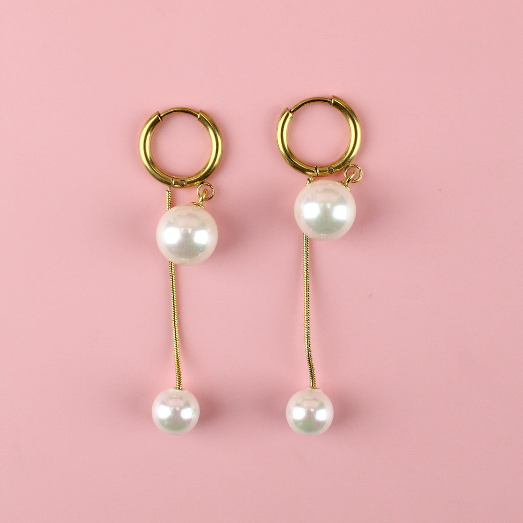 Gold plated drop earrings with a large pearl at the top and small pearl at the bottom