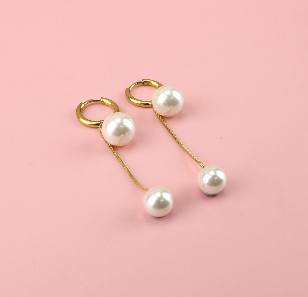Gold plated drop earrings with a large pearl at the top and small pearl at the bottom