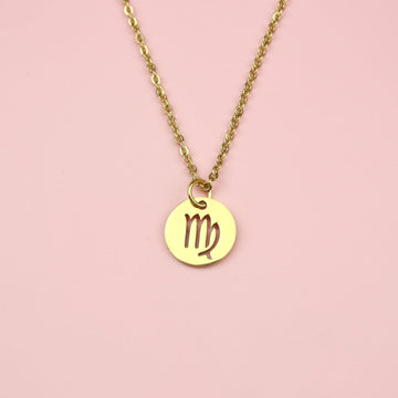 A Stainless Steel/Gold Plated Circle Charm with Cut Out Virgo Symbol on a Gold Plated Stainless Steel Chain