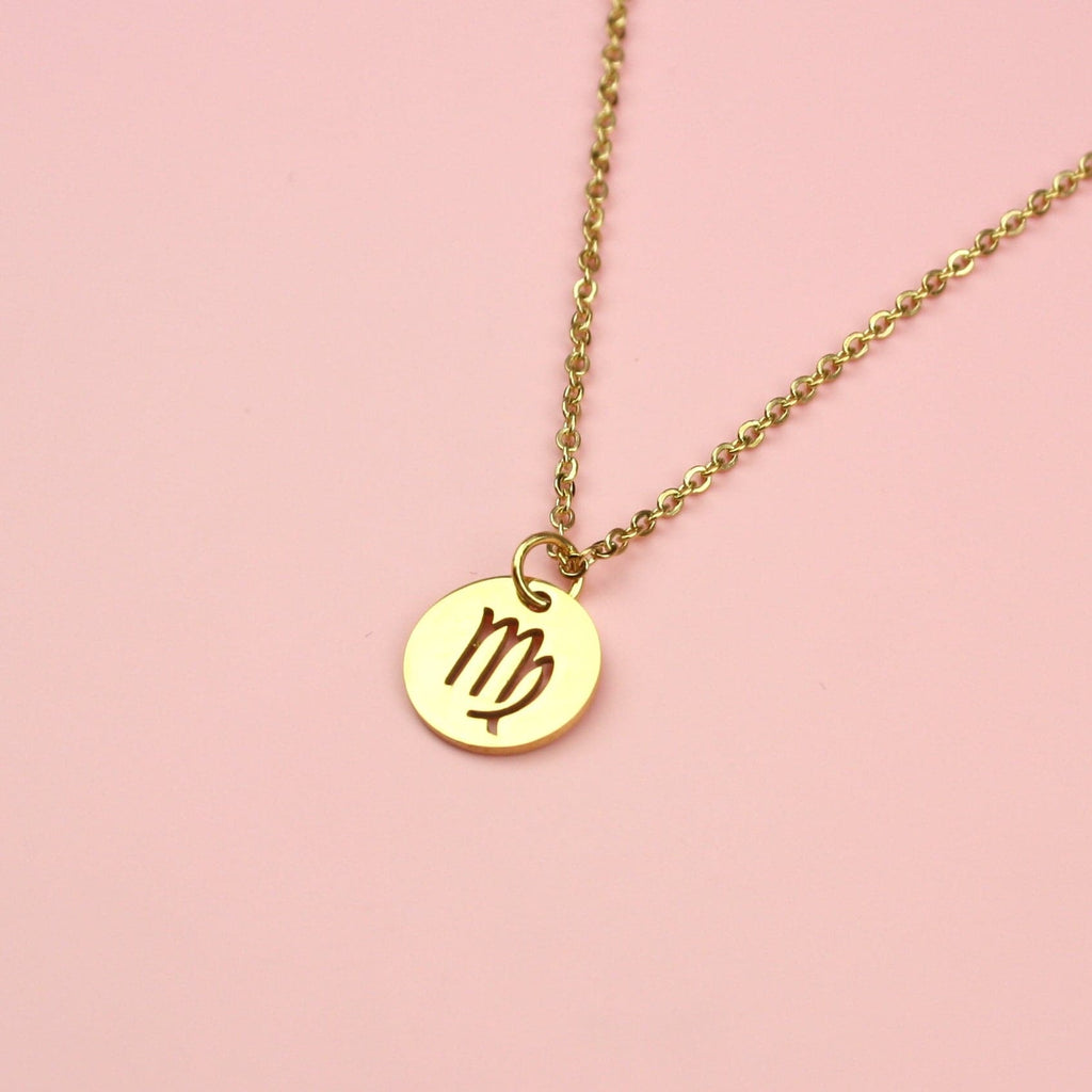 A Stainless Steel/Gold Plated Circle Charm with Cut Out Virgo Symbol on a Gold Plated Stainless Steel Chain