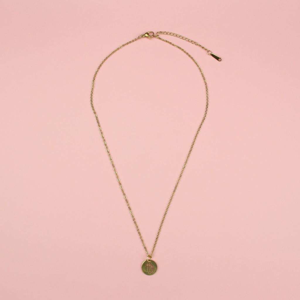 A Stainless Steel/Gold Plated Circle Charm with Cut Out Virgo Symbol on a Gold Plated Stainless Steel Chain