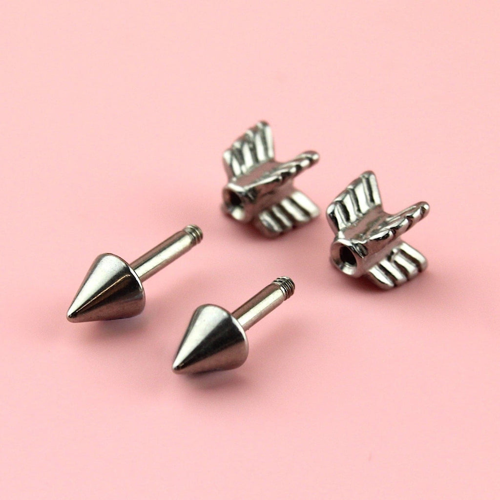 Stainless steel studs in the shape of an arrow with a scew-off back