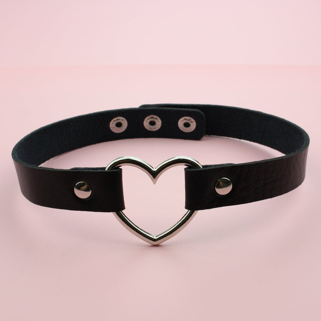 Choker with black leather strap and a metal cut out shaped heart
